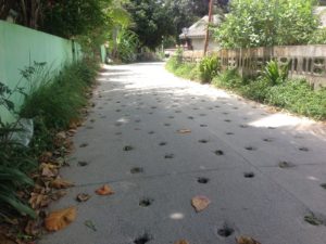 Road with holes for water draining purposes