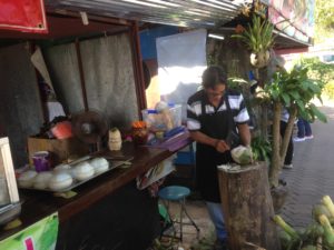 Sob Ruak village - Man removing kernel - Completed product on the left of the picture